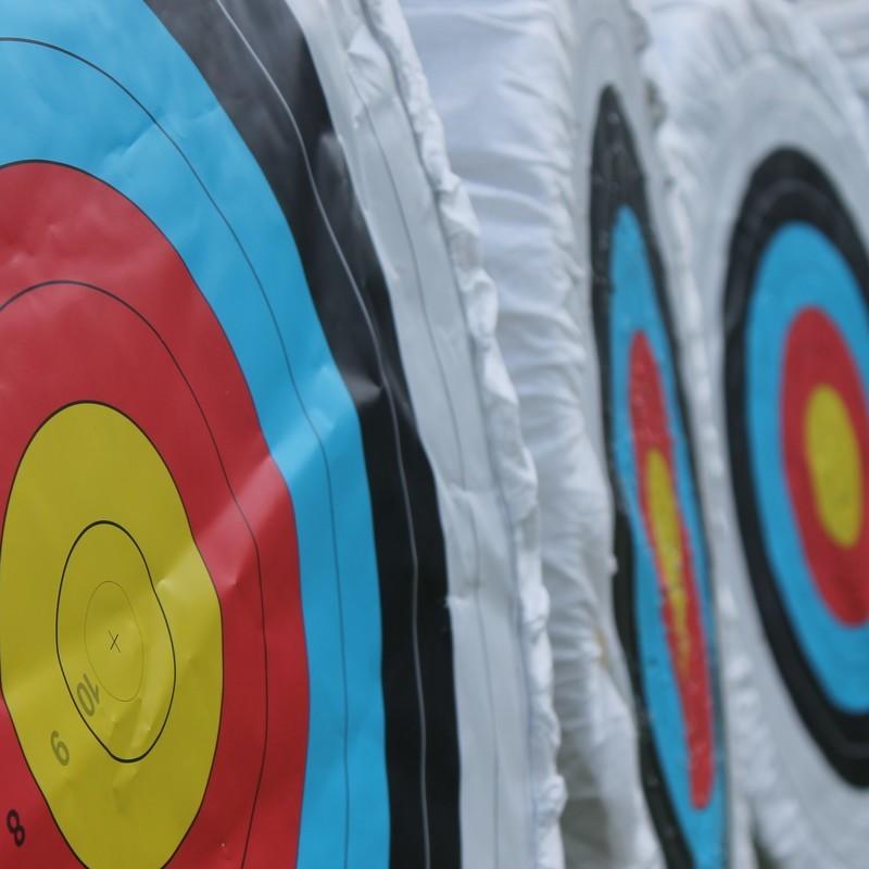 Archery targets with yellow, red, and blue bullseyes